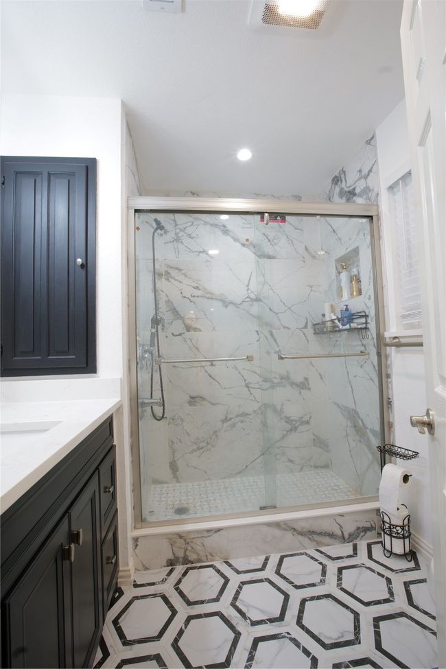 Bathroom featuring a marble finish shower and vanity | Image 19