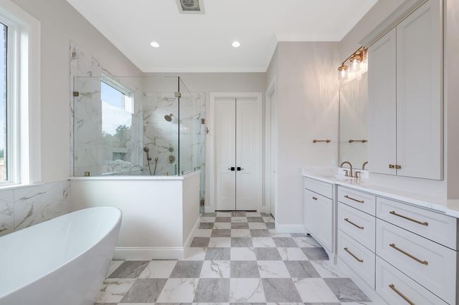 Full bathroom featuring a marble finish shower, a freestanding bath, vanity, and recessed lighting | Image 28