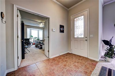 Foyer with ceiling fan, light colored carpet, and ornamental molding | Image 3