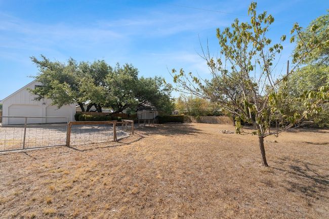 View of yard featuring an outdoor structure and fence | Image 26
