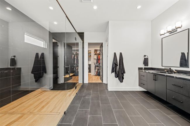 Bathroom featuring vanity, baseboards, recessed lighting, a spacious closet, and tiled shower | Image 24