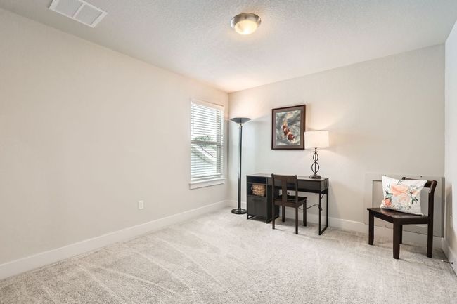 Sitting room featuring carpet and a desk | Image 21