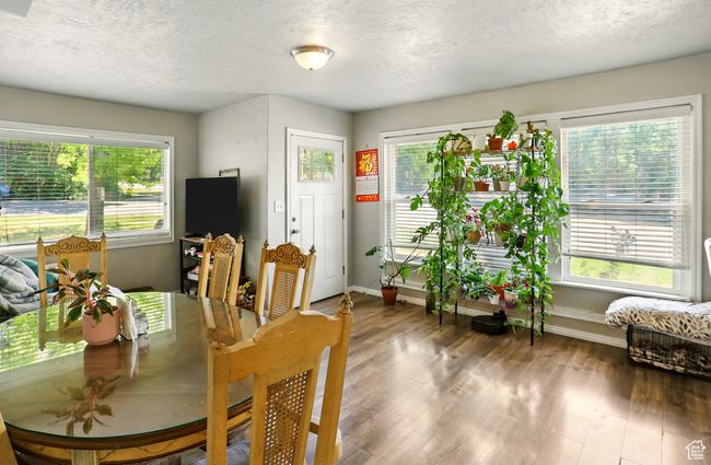 Dining space featuring a textured ceiling and wood finished floors | Image 4