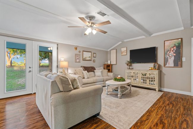Living room with wood finished floors and ceiling fan | Image 19