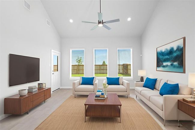 Gather the family and guests together in your lovely family room! Featuring high ceilings, recessed lighting, ceiling fan, custom paint, gorgeous wood look tile floors, and large windows that provide plenty of natural lighting throughout the day. | Image 8