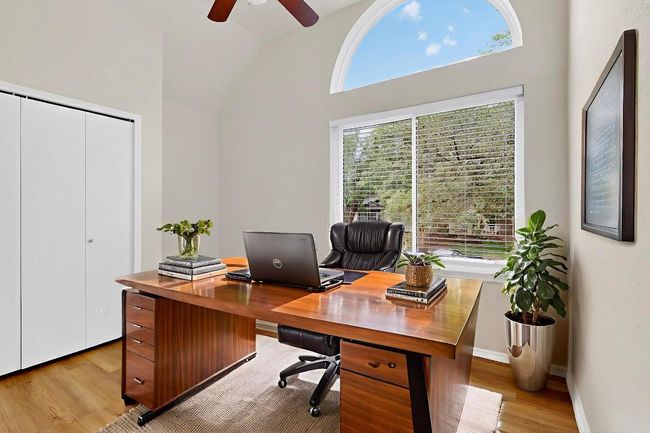 Office with light wood-style floors, ceiling fan, and lofted ceiling | Image 6