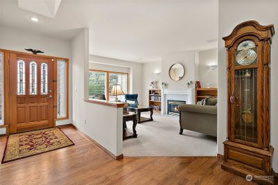 Fabulous hardwood floors and great natural light from a skylight in the foyer of this home | Image 3