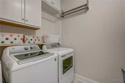 Clothes washing area with washer and dryer and cabinets | Image 2