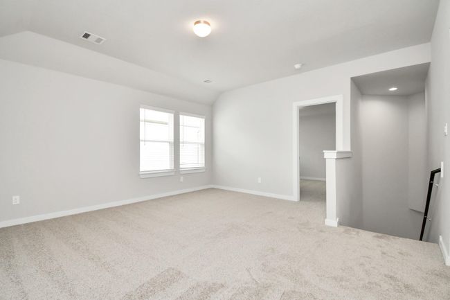Come upstairs and enjoy a day of leisure in this fabulous game room! This is the perfect hangout spot or adult game room! Features plush carpet, high ceilings, custom paint and windows for plenty of natural light. | Image 28