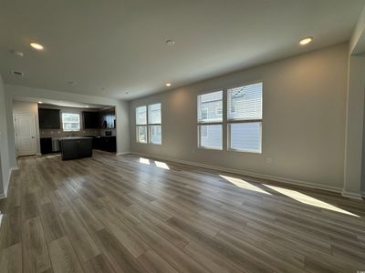 Unfurnished living room with hardwood / wood-style floors and sink | Image 3