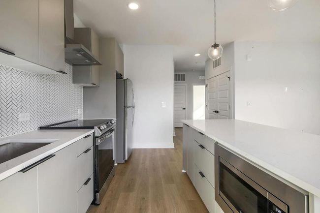 Modern Kitchen with quartz countertops & stainless steel appliances | Image 5