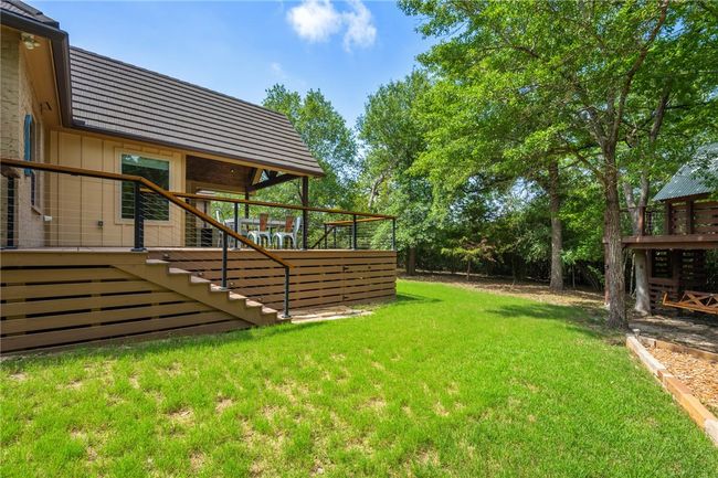 View of green lawn with stairway and a wooden deck | Image 30