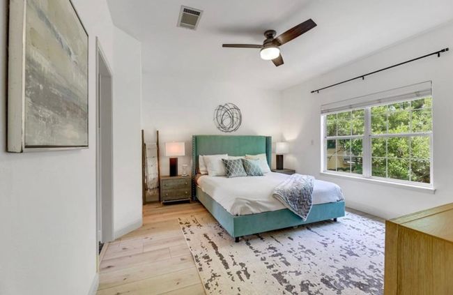 Bedroom featuring baseboards, visible vents, a ceiling fan, and light wood finished floors | Image 17