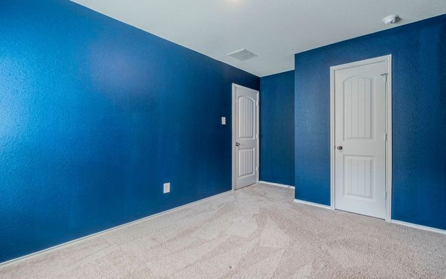 Carpeted spare room featuring a smoke detector and baseboards | Image 15