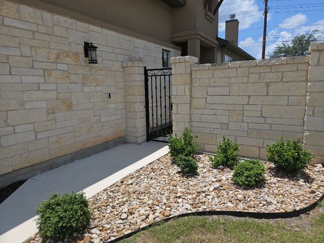 View of side of property featuring a gate and stone siding | Image 4