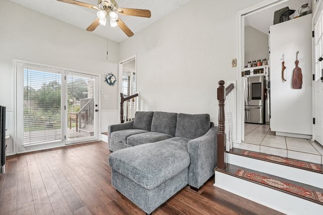 Living room featuring a ceiling fan and wood finished floors | Image 8