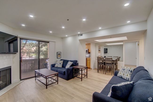 Living room featuring a fireplace and light hardwood / wood-style floors | Image 7
