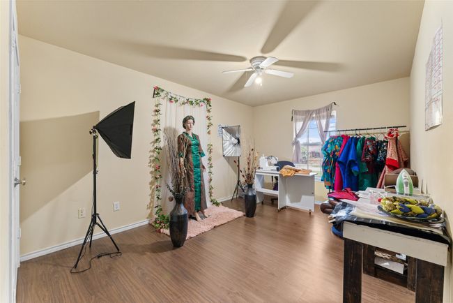 Bedroom with ceiling fan and wood finished floors | Image 22