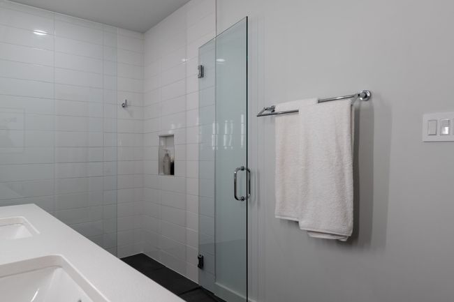 Bathroom with a stall shower and double sink | Image 24
