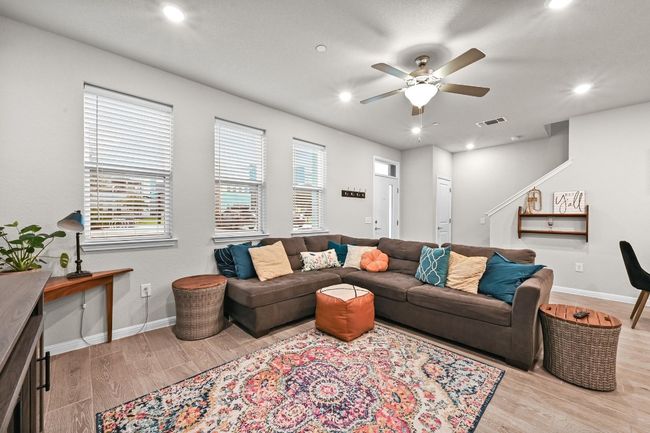 High ceilings elevate the living room, giving it an expansive feel while maintaining a cozy, intimate vibe perfect for relaxation | Image 8