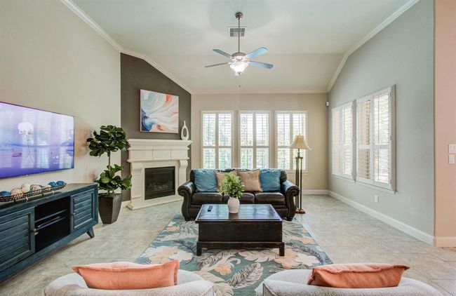 Living room with stone mantel gas log fireplace. | Image 10