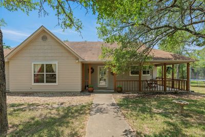 Welcome to 189 Shady Oaks Loop in Cedar Creek the beautiful 8 acres property is covered in mature trees making the property feel spacious and private. | Image 3