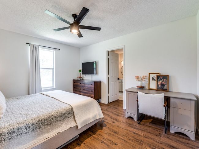 Bedroom featuring wood finished floors, a textured ceiling, and a ceiling fan | Image 21
