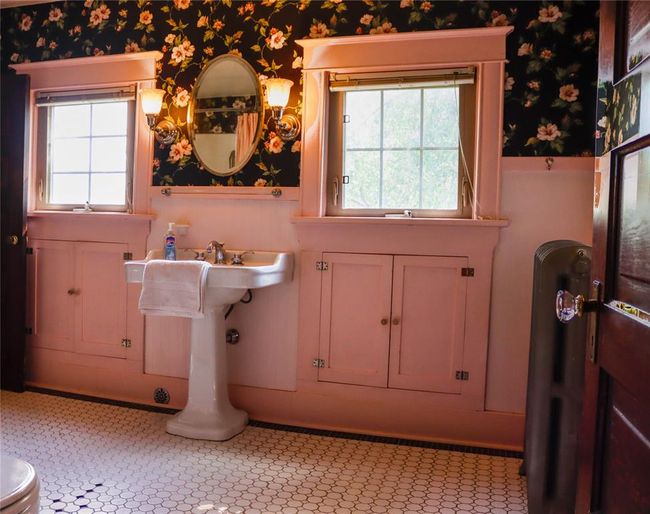 The second floor Bathroom , with built in storage cabinets on both sides of the pedestal sink. | Image 35