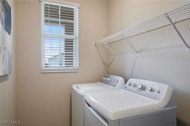 Clothes washing area featuring laundry area and washing machine and dryer | Image 15