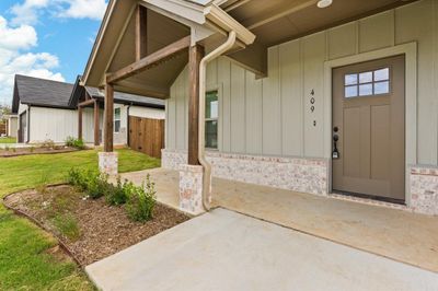 Doorway to property with a lawn and a patio | Image 3