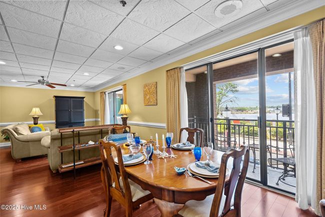 Both diningroom & livingroom delight in cool blue water views, bright sunshine, & breathtaking sunsets | Image 22