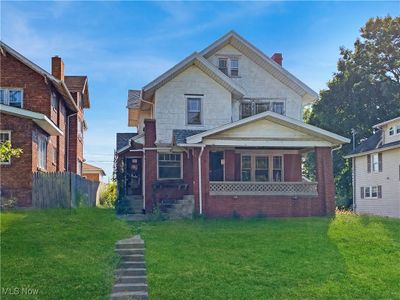 View of front of property with covered porch and a front lawn | Image 1