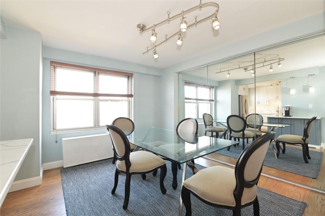 Dining area featuring light wood finished floors, baseboards, and track lighting | Image 5