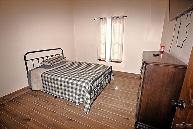 Bedroom featuring dark hardwood / wood-style floors | Image 22