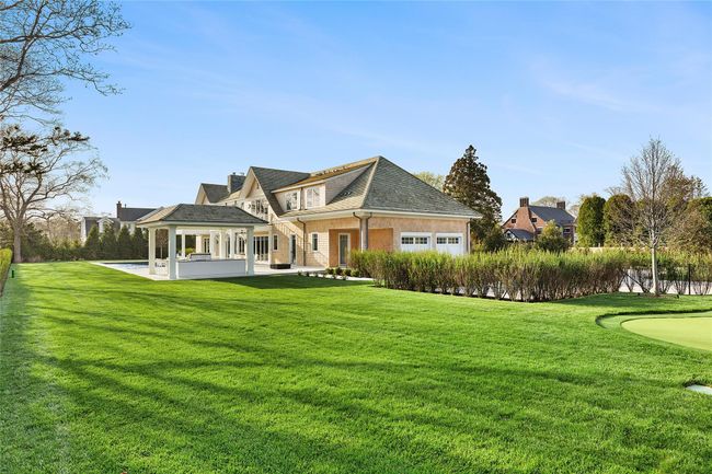 Back of house with a lawn, a patio area, and a 2 car garage | Image 40