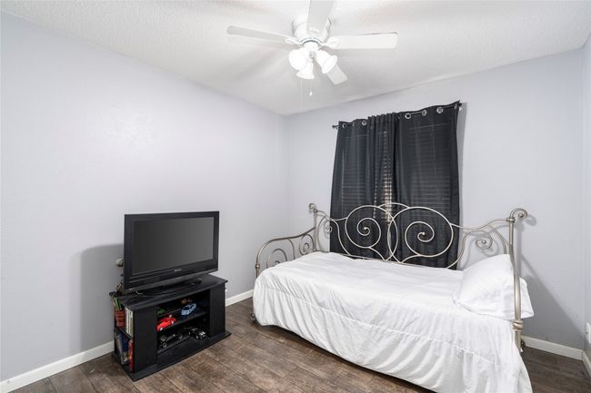 Bedroom featuring dark hardwood / wood-style flooring, ceiling fan, and a textured ceiling | Image 16