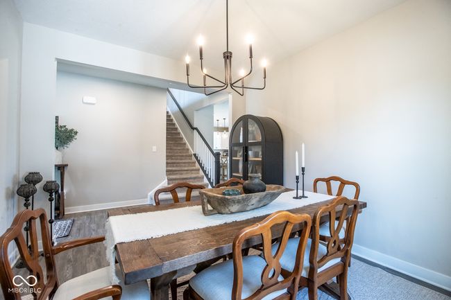 dining room with a chandelier, wood finished floors, and stairway | Image 9