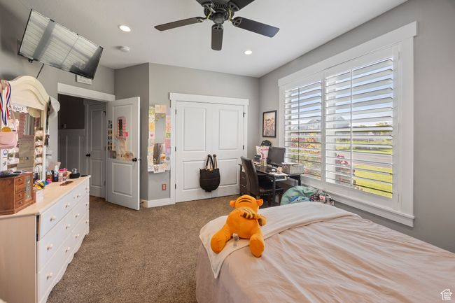 Bedroom with carpet, recessed lighting, a ceiling fan, a closet, and an office area | Image 43