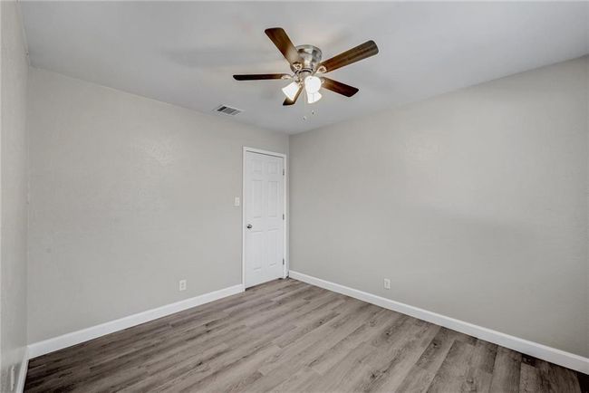 Unfurnished room with baseboards, wood finished floors, and a ceiling fan | Image 15