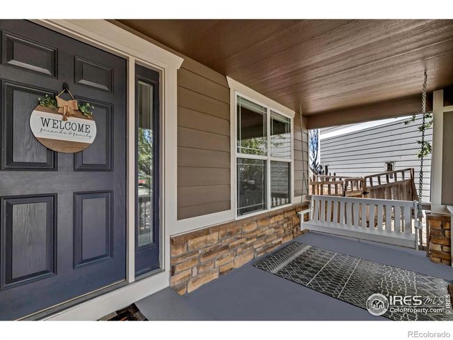 Covered front porch with porch swing creates the perfect place to watch your kids play in the front yard and cul-de-sac! | Image 4