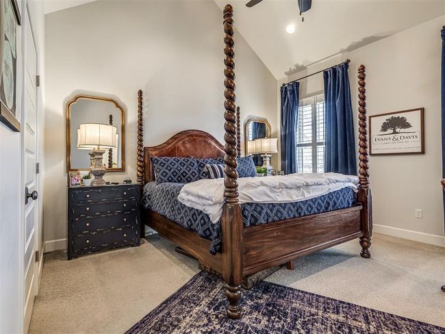 Carpeted bedroom with ceiling fan, baseboards, and vaulted ceiling | Image 18