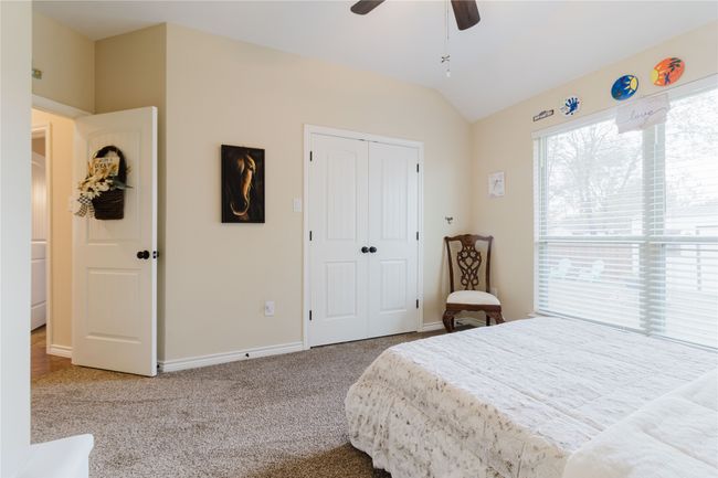 Bedroom #2 featuring carpet floors, a closet, ceiling fan, and lofted ceiling | Image 17