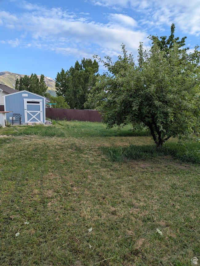 View of yard with a storage shed, an outbuilding, and a mountain view | Image 28