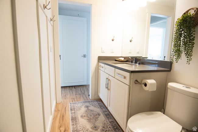 Bathroom with toilet, wood finished floors, and vanity | Image 18