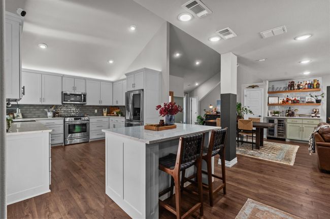 Kitchen with appliances with stainless steel finishes, light stone countertops, and decorative backsplash | Image 8