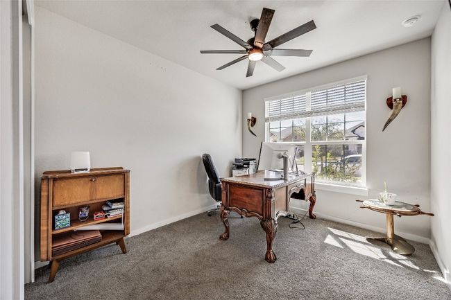 Secondary main level bedroom being used as a home office | Image 23