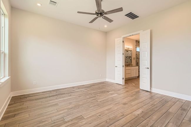 Unfurnished bedroom featuring light wood-type flooring, visible vents, and recessed lighting | Image 17