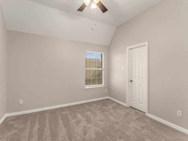 Unfurnished room with vaulted ceiling, baseboards, a ceiling fan, and carpet floors | Image 32