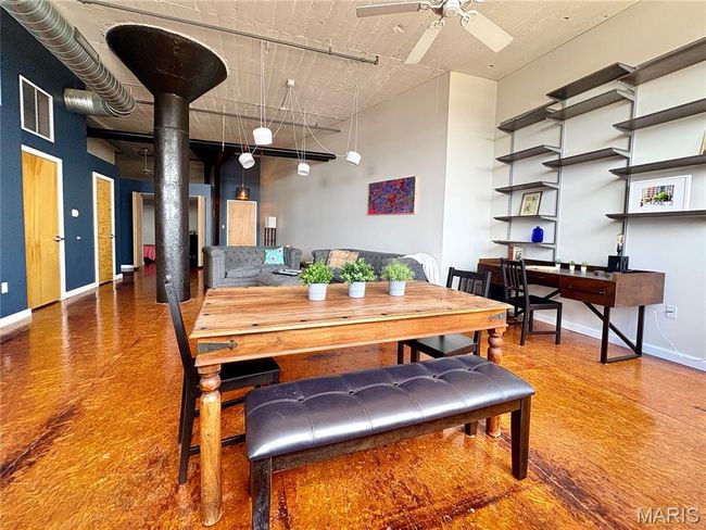 Dining space featuring a ceiling fan and a high ceiling | Image 6