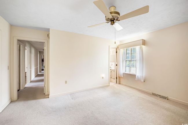 Unfurnished room with carpet, ceiling fan, and baseboards | Image 21